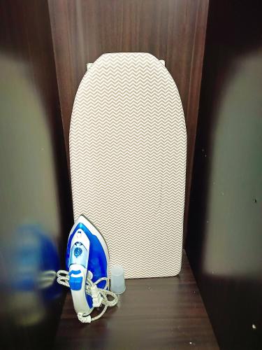 a blue and white shoe sitting next to a suitcase at 2412T2 Avida Towers Cebu IT Park 1BR Unit Queen Bed in Cebu City