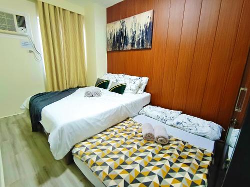 two beds sitting next to each other in a room at 2412T2 Avida Towers Cebu IT Park 1BR Unit Queen Bed in Cebu City