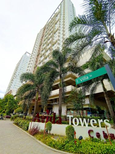 a street sign in front of a large building at 2412T2 Avida Towers Cebu IT Park 1BR Unit Queen Bed in Cebu City