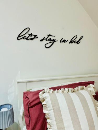 a let fly in bed sign on a wall at Cosy Hideaway Studio in Walsall in Pelsall