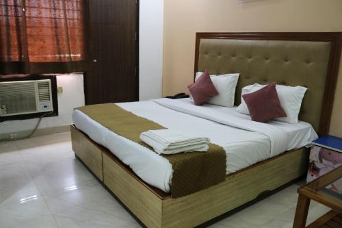 a bedroom with a large bed with towels on it at Vinayak Stay Sector 43 in Gurgaon