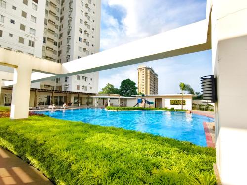 a swimming pool in a building with tall buildings at 2412T2 Avida Towers Cebu IT Park 1BR Unit Queen Bed in Cebu City