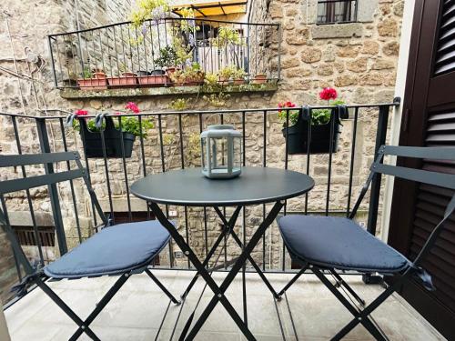 a small table and two chairs on a balcony at WelcHome Vitorchiano in Vitorchiano