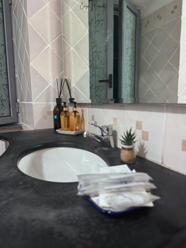 a bathroom counter with a sink and a mirror at Marieta Rooms in Sarzana