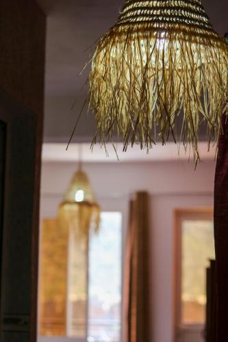 a pendant light hanging from a ceiling at Auberge Les Montagnes du Paradis Your Hidden Retreat in Paradise Valley in Agadir