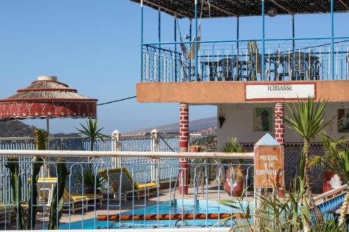 a resort with a swimming pool and a balcony at Auberge Les Montagnes du Paradis Your Hidden Retreat in Paradise Valley in Agadir