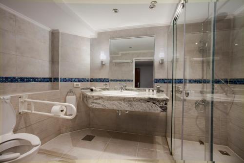a bathroom with a toilet and a sink and a shower at Acamar Nile Cruise - Every Monday from Luxor for 04 & 07 Nights - Every Friday From Aswan for 03 & 07 Nights in Luxor