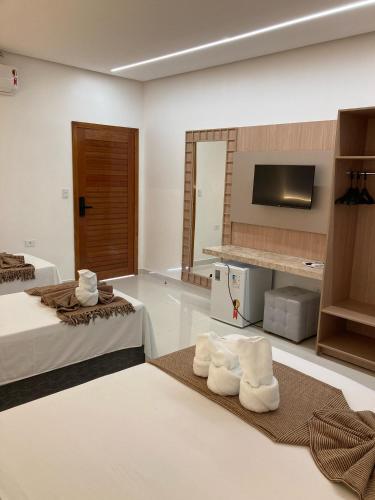 Ένα ή περισσότερα κρεβάτια σε δωμάτιο στο Cânions Hotel