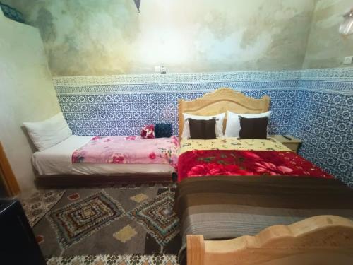 two beds sitting next to each other in a room at RIaD DRISSIA Panoramic in Fez