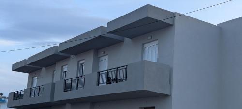 a building with balconies on the side of it at Lilac Kefalos in Kefalos