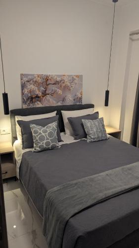 a bedroom with a large bed with pillows on it at Lilac Kefalos in Kefalos