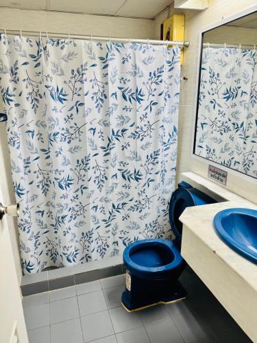 a bathroom with a blue and white shower curtain at Oceanside Place Beach Resort in Ban Tha Fat