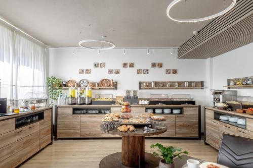 a large kitchen with a table with food on it at Best Western Hotel Residence Italia in Quartu SantʼElena
