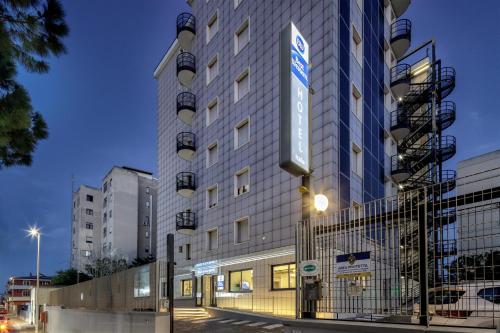 a building with a sign on the side of it at Best Western Hotel Residence Italia in Quartu SantʼElena