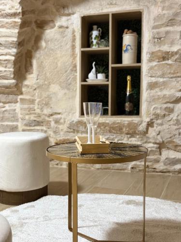 a table in a living room with a wine glass on it at I CAVALIERI in Terlizzi