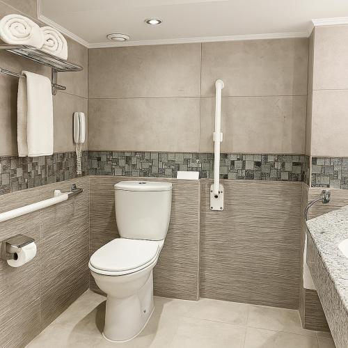 a bathroom with a toilet and a sink at Acamar Nile Cruise - Every Monday from Luxor for 04 & 07 Nights - Every Friday From Aswan for 03 & 07 Nights in Luxor