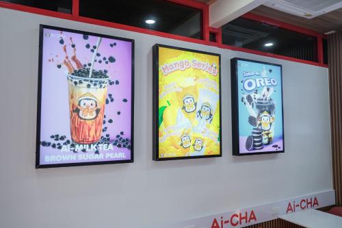 a group of four posters on a wall at Lorjula INN in Hat Yai