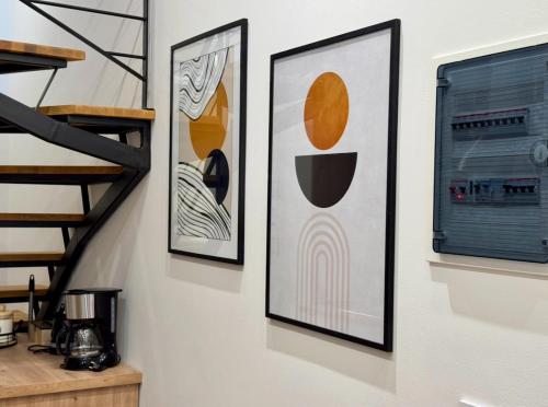 three framed pictures on a wall in a room at Laura s Luxury Loft in Mytilini