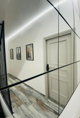 a staircase with glass railings and a door at WelcHome Vitorchiano in Vitorchiano