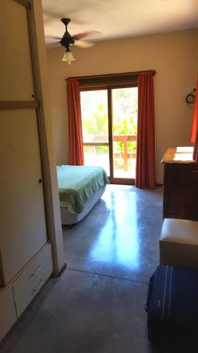 a bedroom with a bed and a sliding glass door at PiedrasBlancas in Mar de las Pampas