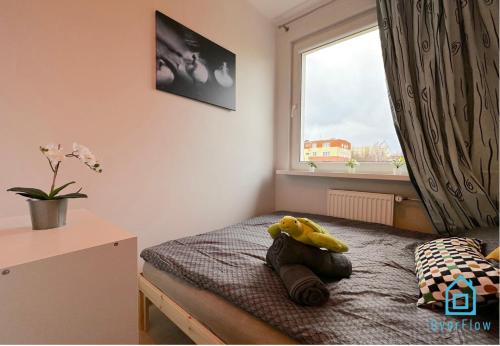 a bedroom with a teddy bear sitting on a bed at Turtle Room - 3 km to Baltic Sea in Gdańsk