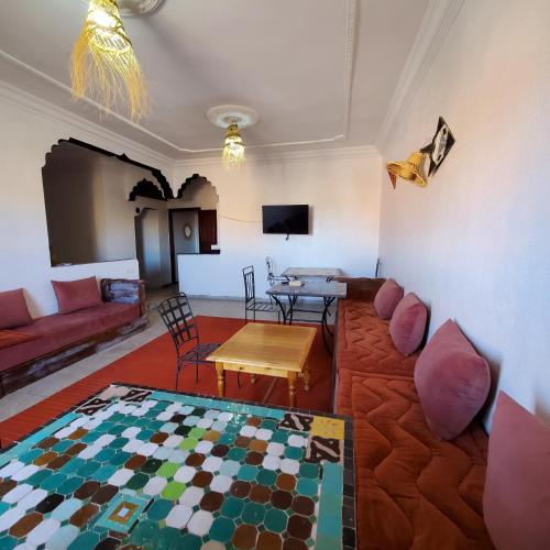 a living room with a couch and a table at WARZAZAT Hostel in Ouarzazate