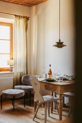 a dining room with a table with a bottle of wine at Staudingerhof in Staudach-Egerndach