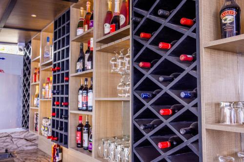 a wine cellar with wine bottles and wine glasses at Hilton Palace Hotel in Kano