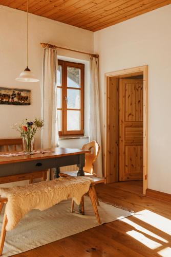a dining room with a table and a window at Staudingerhof in Staudach-Egerndach