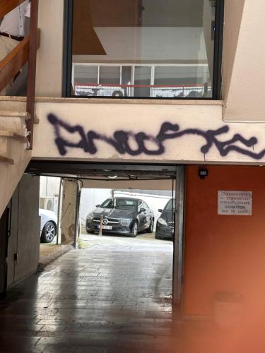 a parking lot with graffiti on the side of a building at Stay Central in Ioannina