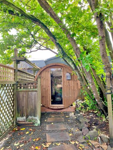 a wooden shed with a gate and a fence at Shelburne Hotel in Seaview