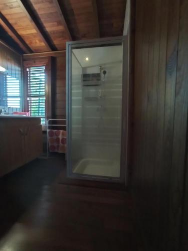 a bathroom with a glass shower in a room at Alamanda in Sainte-Anne