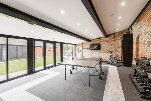 an office with a table in a room with windows at Sutton Hall, Norfolk in Hickling