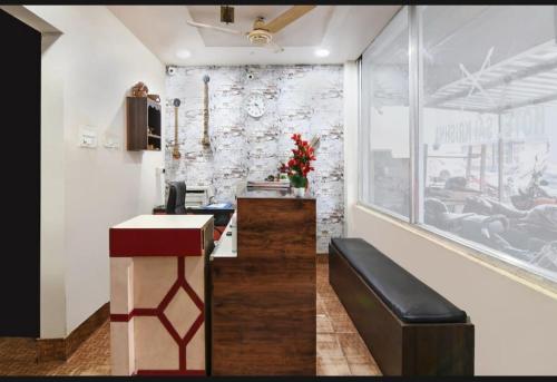 a lobby of a restaurant with a bar with a bench at Hotel VentureInn Nxe ITER Khandagiri - Airport - Lingaraj Temple in Bhubaneshwar