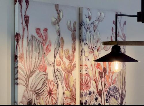 a curtain with a flower design on a wall at Iris Luxury Loft in Mytilini