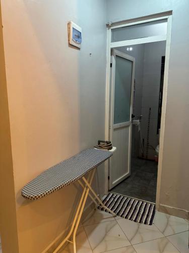 a room with a treadmill in front of a door at Global in Jinja