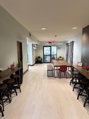 an empty room with tables and chairs and a table at Valued Stay Aloha in Madison