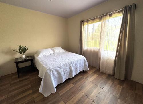a bedroom with a bed and a window at Casa De Daniel in Daniel Flores