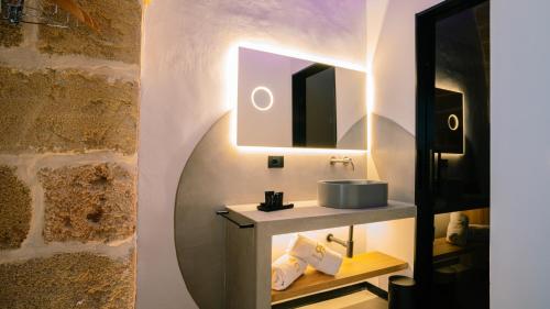 a bathroom with a sink and a mirror at Regina Elena Suites & Private SPA in Sannicola