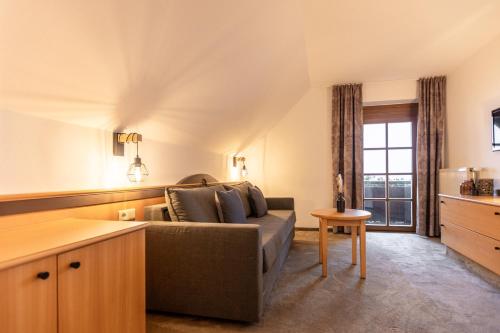 a living room with a couch and a table at Wohnen beim Wein Tschermonegg in Sulz