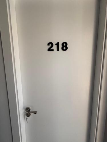 an open door with the number on it at Hostal Los Mellizos in Conil de la Frontera