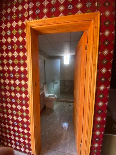 an open door to a bathroom with a toilet at Wadi Rum Santa Camp in Wadi Rum