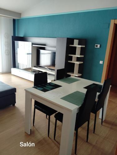 a dining room with a white table and chairs at Apartamento ROMA in Nájera