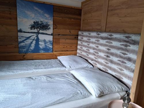a bedroom with a bed with a tree in it at Hüttenzauber in Taxenbach