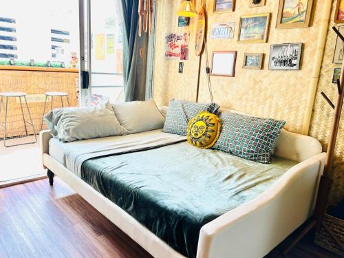 a couch with pillows on it in a room at Surf & Sip Ocean View Tiki Style in Honolulu