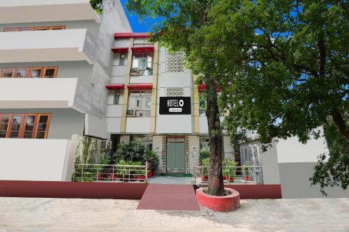 a building with a sign in front of it at Super Hotel O SGPGI in Lucknow