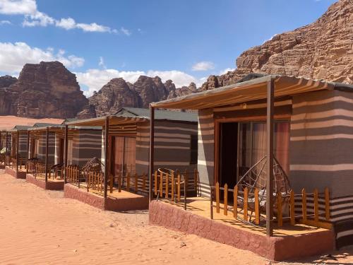 a row of wooden huts in the desert at Wadi Rum Santa Camp in Wadi Rum
