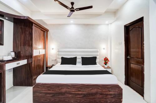 a bedroom with a large bed and a ceiling fan at Super Hotel O SGPGI in Lucknow