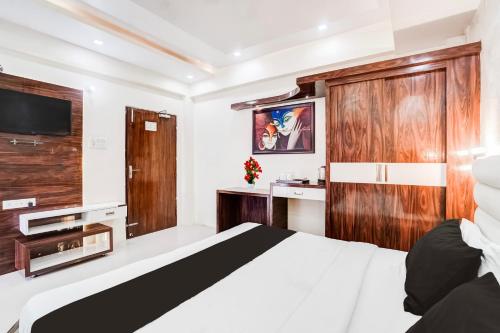 a hotel room with a bed and a tv at Super Hotel O SGPGI in Lucknow