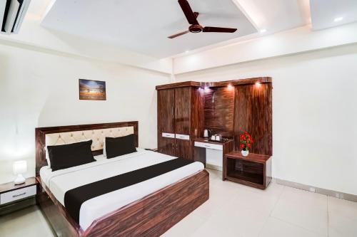a bedroom with a bed and a ceiling fan at Super Hotel O SGPGI in Lucknow